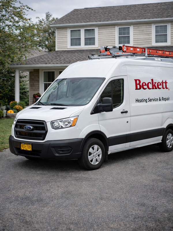 Technician performing Beckett oil burner maintenance on Long Island